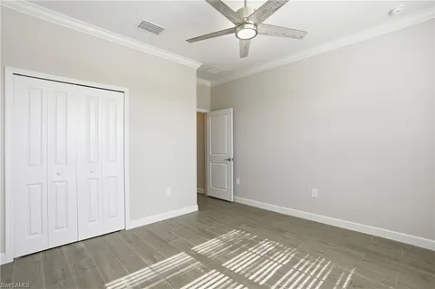 an empty room with a ceiling fan and a window
