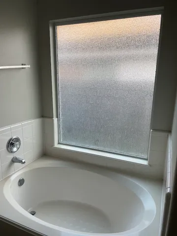a bathroom with a glass door shower
