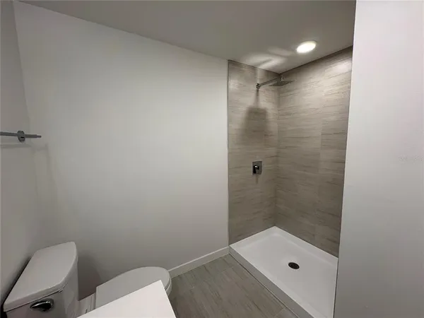 a bathroom with a shower and toilet
