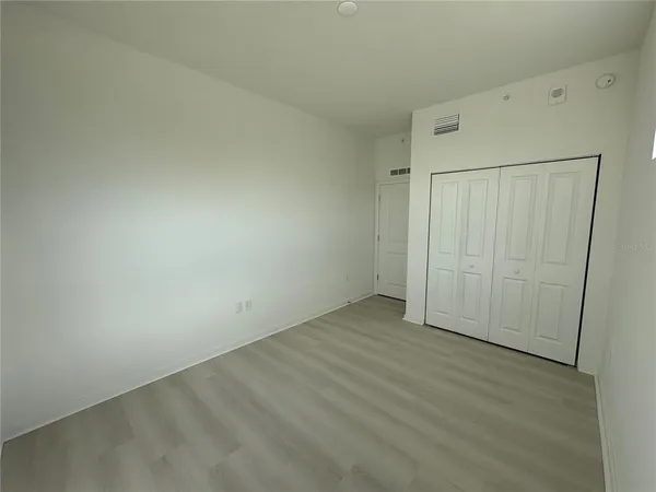 an empty room with wooden floor