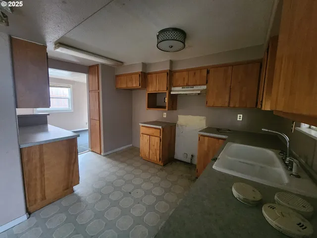 a kitchen with a sink stove and cabinets