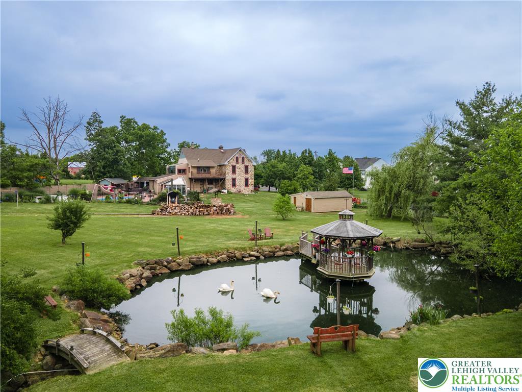 2485 Hieter Road Quakertown, PA 18951 - Photo 79 of 97 Discover a tranquil estate featuring a private pond with a charming gazebo and a sprawling green landscape.