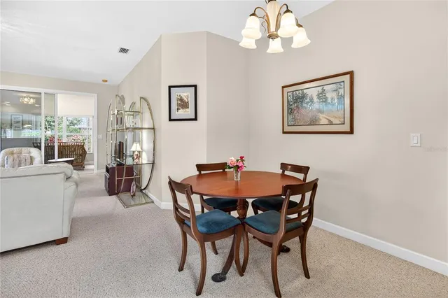 a view of a dining room with furniture and chandelier