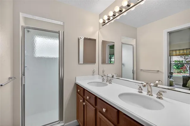 a bathroom with a glass shower door