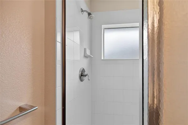 a bathroom with a glass shower door
