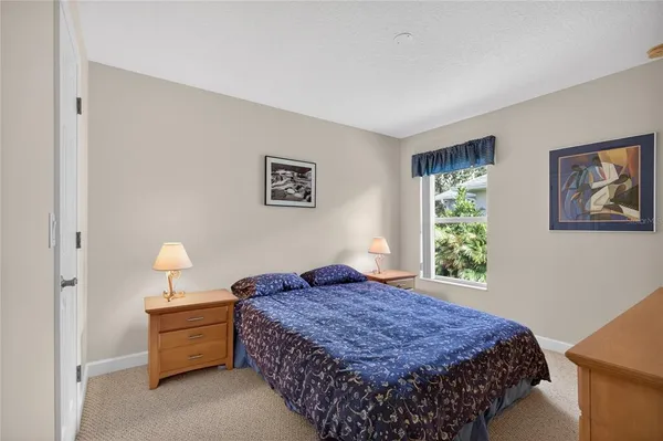 a bedroom with bed and window