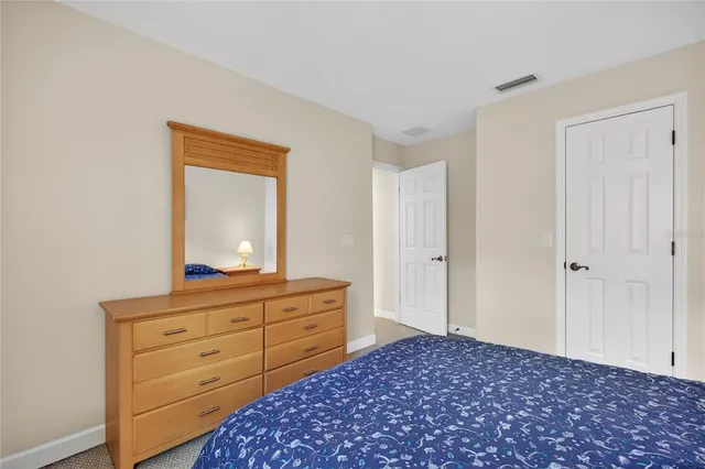 a bedroom with a bunk bed and a lamp on dresser