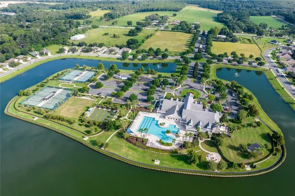 an aerial view of a house with a garden and lake view