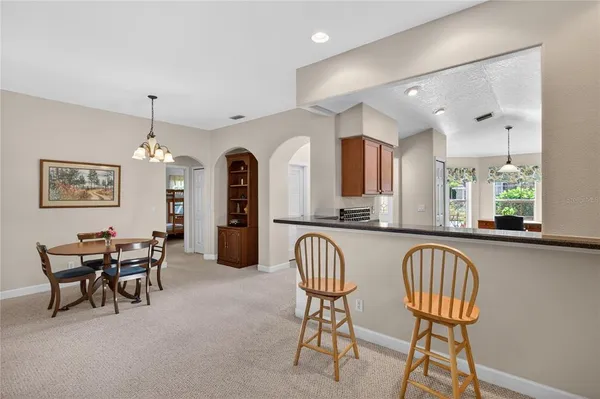 a view of a a dining room with furniture window and wooden floor