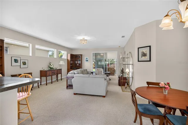 a view of a a dining room with furniture window and wooden floor