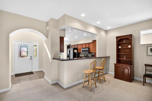 a kitchen with granite countertop a sink stainless steel appliances and cabinets