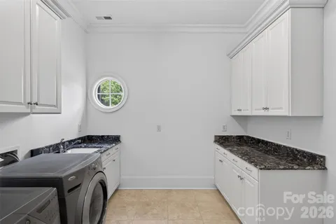a kitchen with a sink a stove and cabinets