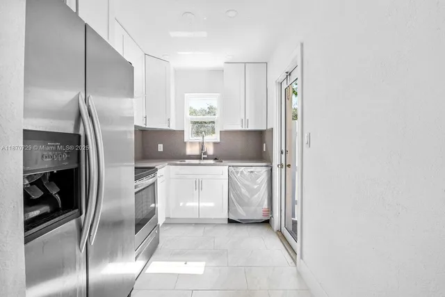 a kitchen with stainless steel appliances a refrigerator and a stove