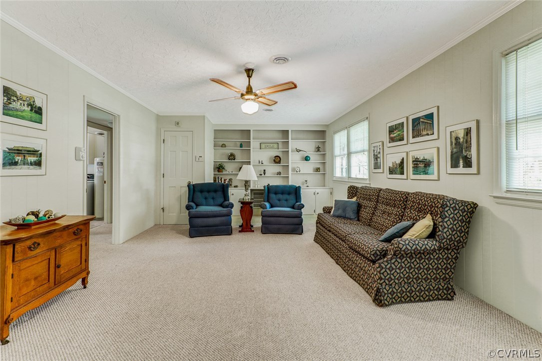 11431 Rochelle Road Chester, VA 23831 - Photo 13 of 23 a living room with furniture and a chandelier