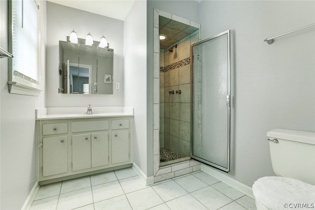 11431 Rochelle Road Chester, VA 23831 - Photo 17 of 23 a spacious bathroom with a shower sink and mirror