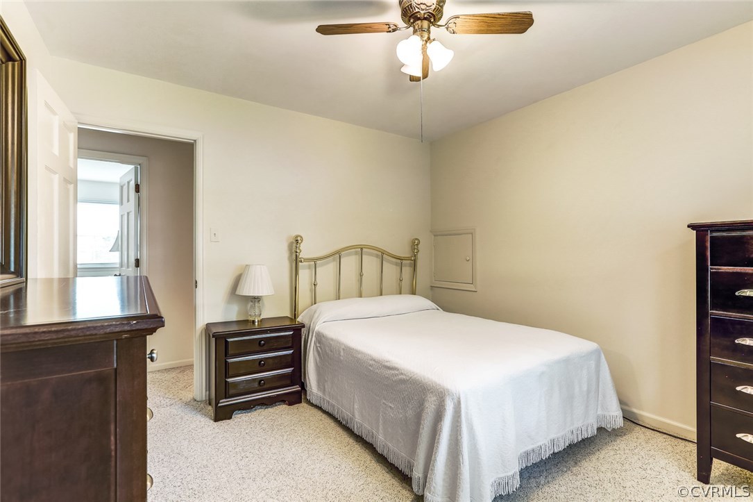 11431 Rochelle Road Chester, VA 23831 - Photo 18 of 23 a bedroom with a bed and a chandelier