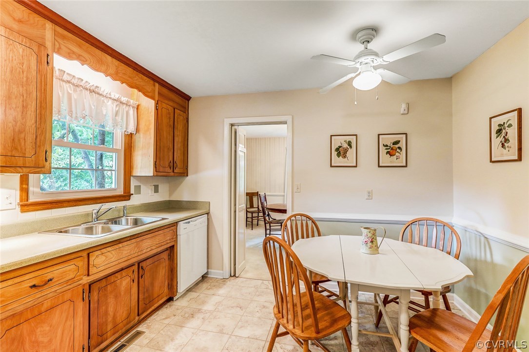 11431 Rochelle Road Chester, VA 23831 - Photo 7 of 23 a kitchen with a table chairs sink and cabinets