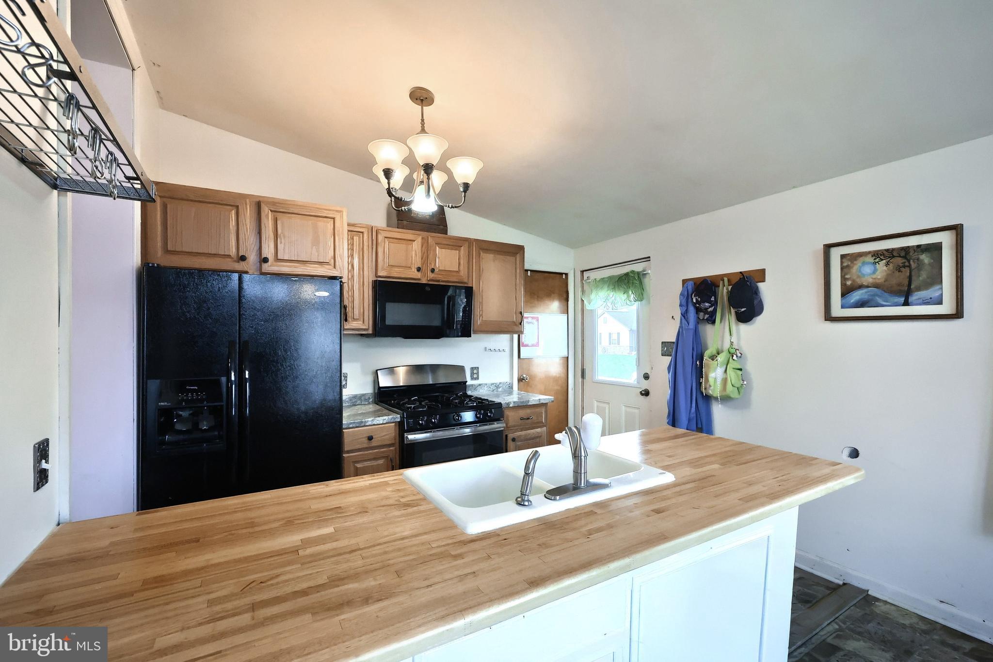 3160 Jessica Road Dover, PA 17315 - Photo 12 of 32 a kitchen with a center island and stainless steel appliances