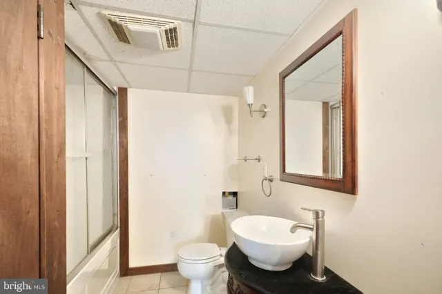 a bathroom with a glass shower door