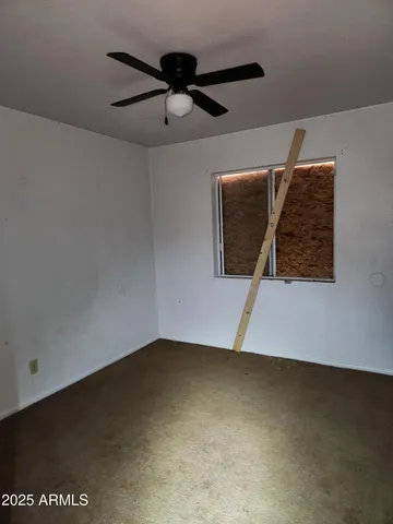 a view of staircase with a ceiling fan
