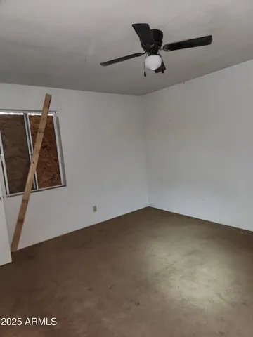 a view of empty room with ceiling fan