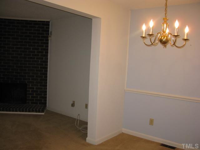813 Green Ridge Drive Raleigh, NC 27609 - Photo 22 of 22 Open Floor Plan allows you to enjoy your fireplace and new LR Wall of windows and doors from your Dining Room. Dining Room
