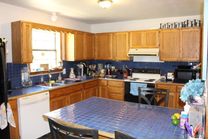 17075 County Road 220 Salida, CO 81201 - Photo 5 of 18 a kitchen with stainless steel appliances granite countertop a stove a sink dishwasher and cabinets with wooden floor