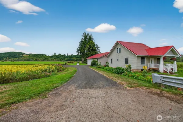 a front view of a house with a yard and lake view