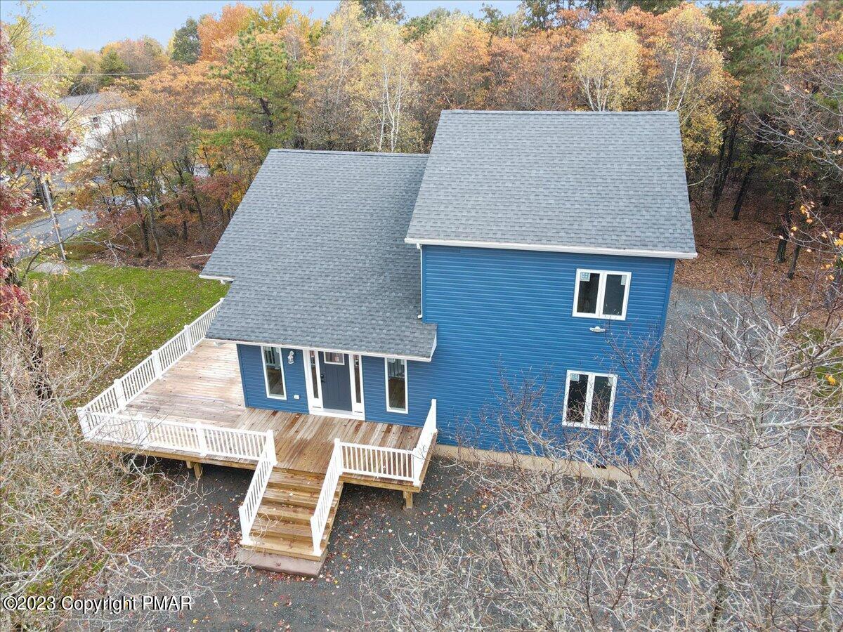 an aerial view of a house with backyard porch and sitting area