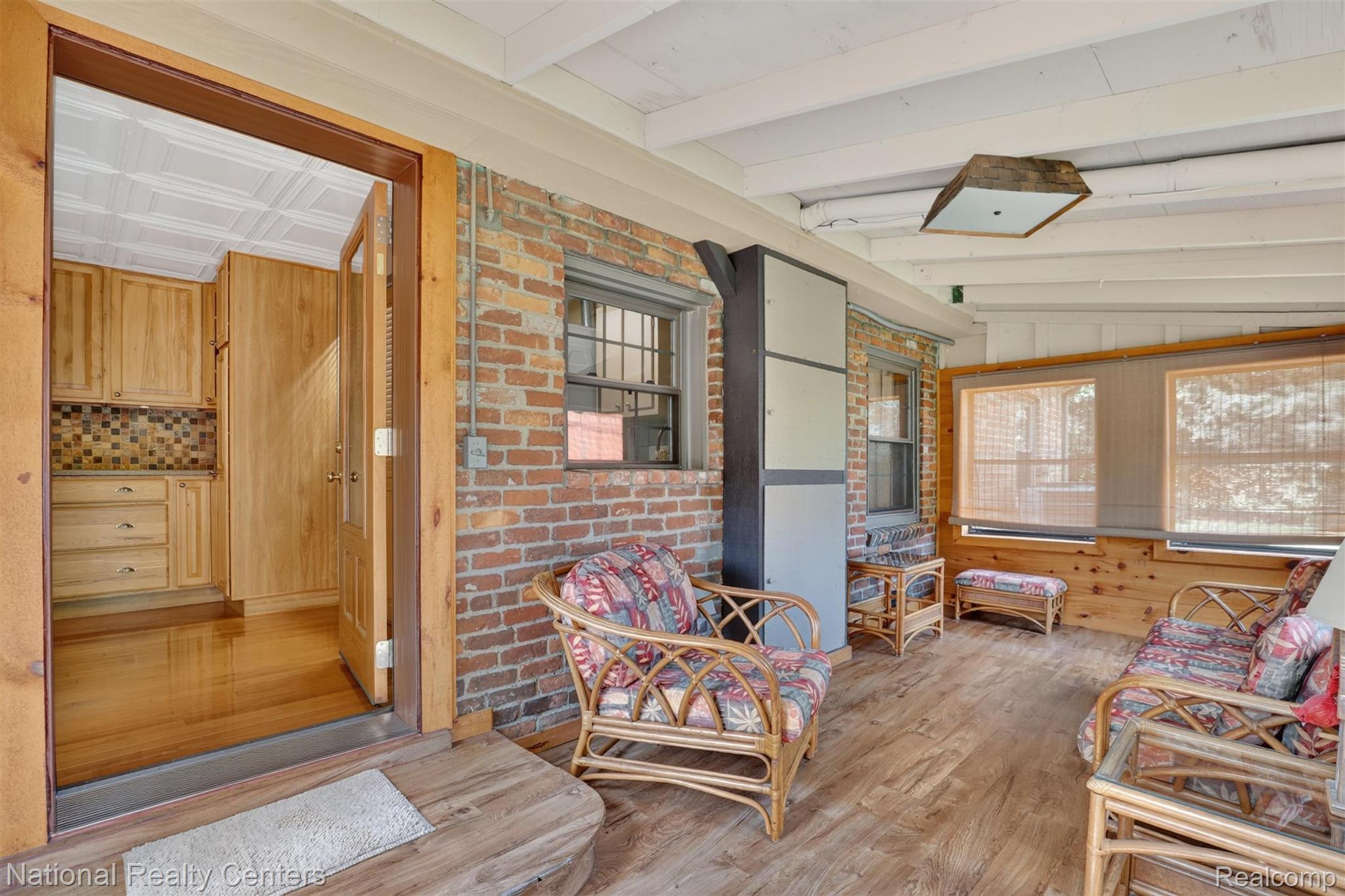 127 West Albain Road Petersburg, MI 49270 - Photo 43 of 61 Enclosed porch featuring wood-finish flooring, exposed brick wall, and multiple windows