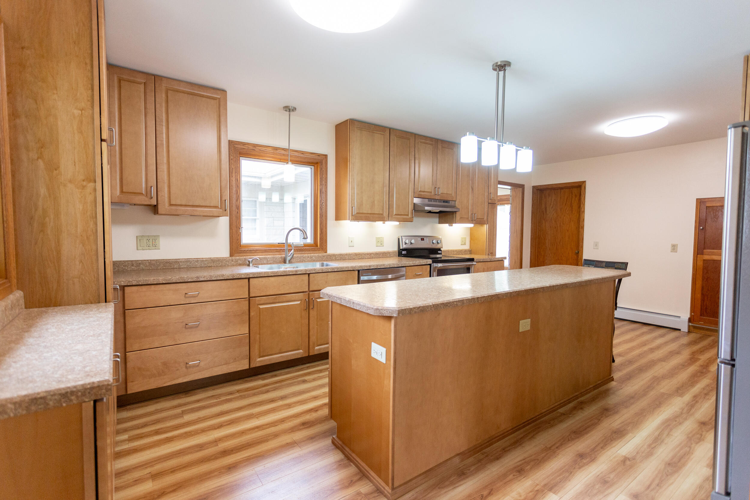 601 East Main Street La Crosse, IN 46348 - Photo 11 of 29 a kitchen with kitchen island a counter top space a sink stainless steel appliances and cabinets