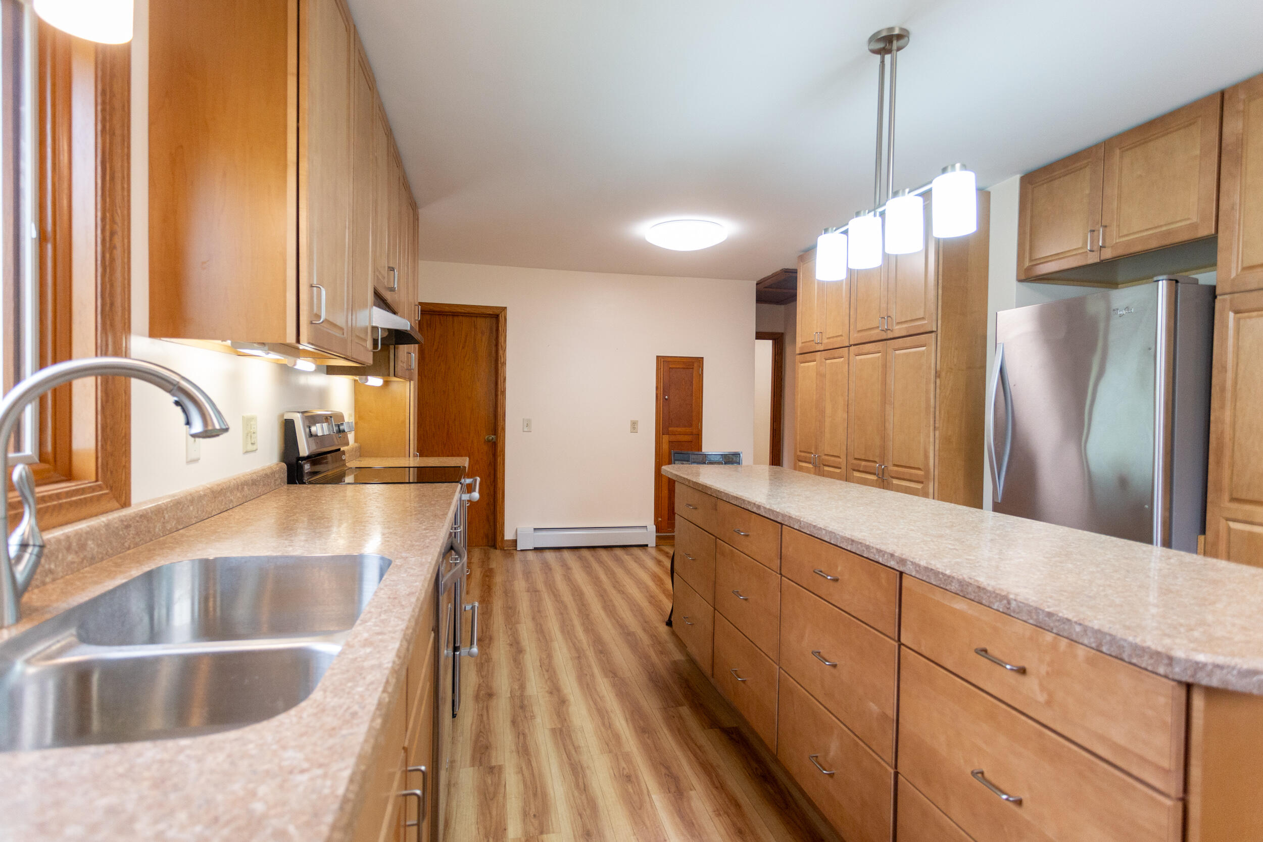 601 East Main Street La Crosse, IN 46348 - Photo 12 of 29 a kitchen with kitchen island granite countertop a sink a counter space appliances and cabinets