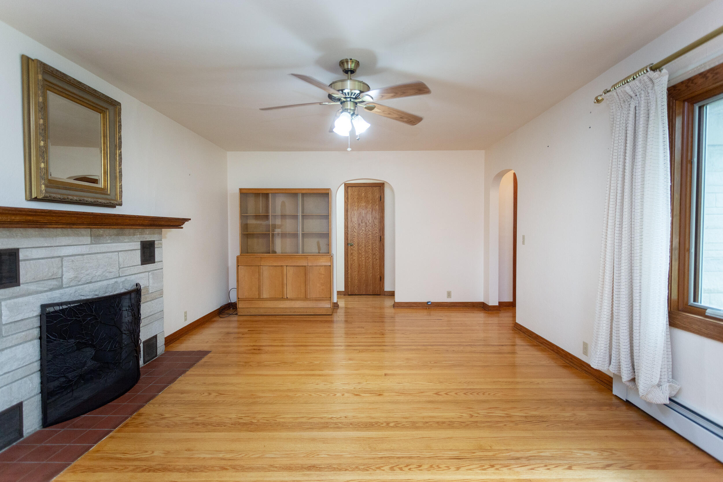 601 East Main Street La Crosse, IN 46348 - Photo 7 of 29 a view of an empty room with wooden floor and a fireplace