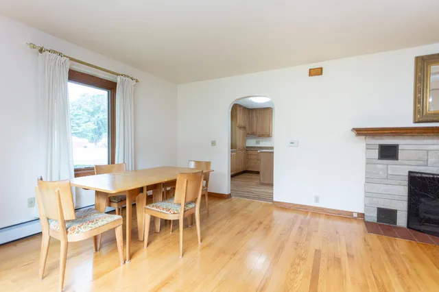 a view of a dining room with furniture and a fireplace