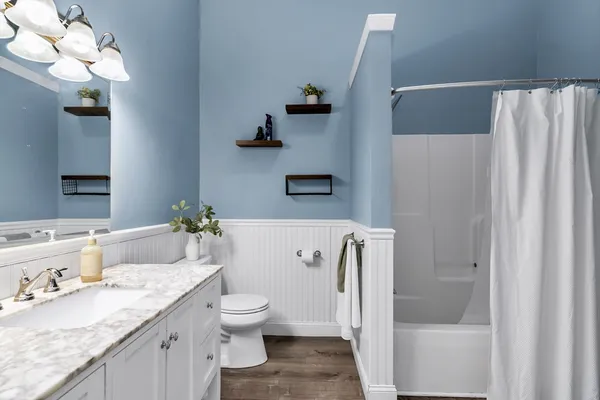 a bathroom with a shower curtain and a toilet