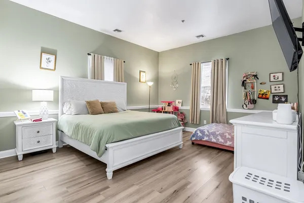a bedroom with a bed and a dresser