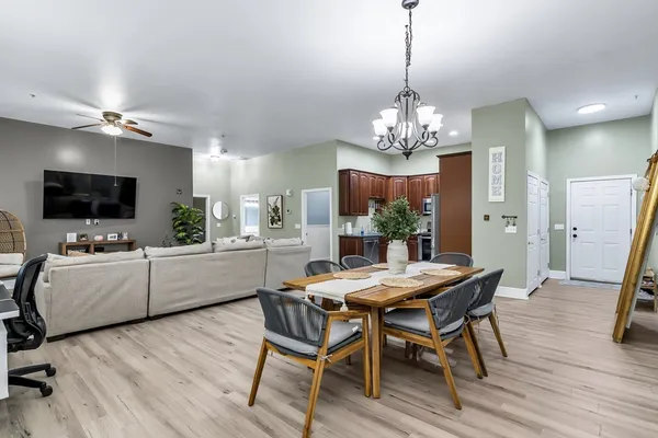 a view of a dining room with furniture wooden floor and a chandelier