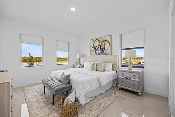 a bedroom with a bed and painting on the wall