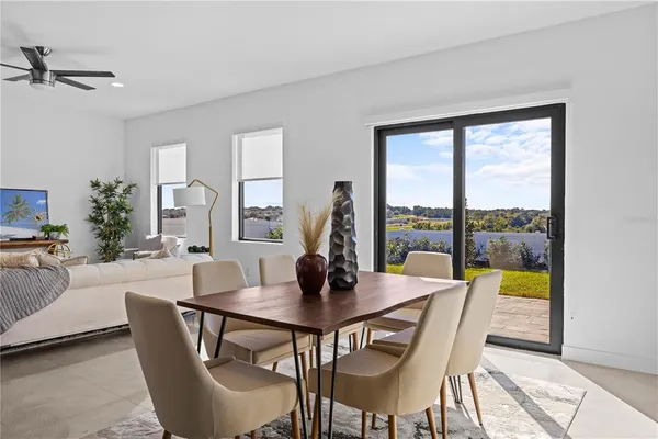 a dining room with furniture a chandelier and wooden floor