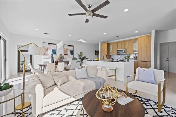 a living room with furniture and kitchen view