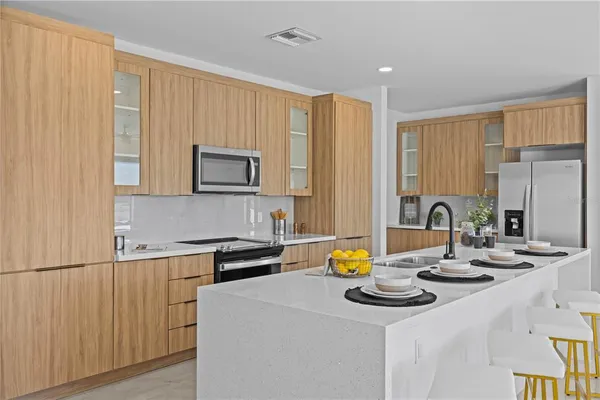 a kitchen with a sink cabinets and wooden floor
