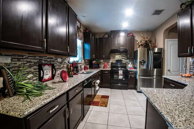 a kitchen with granite countertop stainless steel appliances and a counter top