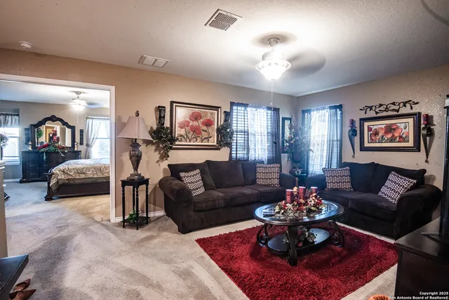 a living room with furniture and a chandelier