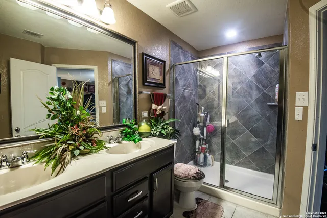 a bathroom with a shower a mirror and a toilet