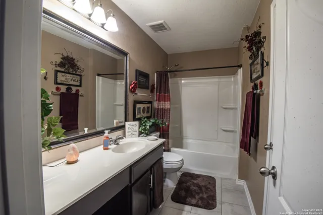 a bathroom with a sink a toilet a shower and a mirror