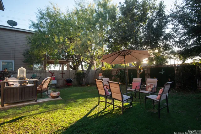 a view of a house with backyard sitting area and garden