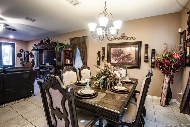 a view of a dining room with furniture and chandelier