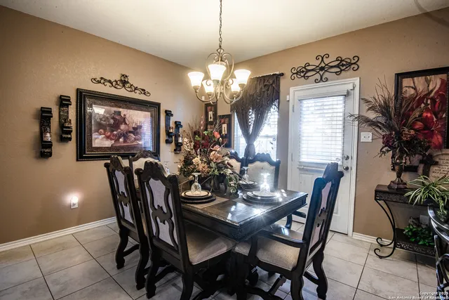 a view of a dining room with furniture and chandelier