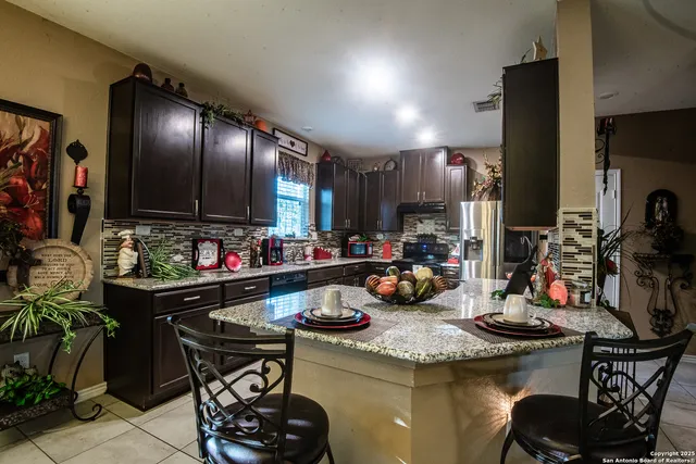 a kitchen with sink refrigerator and cabinets