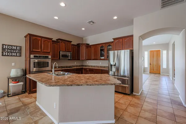 a kitchen with stainless steel appliances granite countertop a sink counter space and cabinets